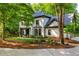 Charming two-story home with manicured landscaping surrounded by mature trees at 210 Hunters Vw, Roswell, GA 30075