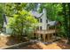 The home features an upper deck and stairs that lead to an outdoor patio at 210 Hunters Vw, Roswell, GA 30075