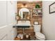 Charming powder room with unique wood paneling, decorative mirror, and vintage-style sink at 210 Hunters Vw, Roswell, GA 30075