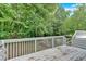 Back deck featuring steps leading to a green backyard space surrounded by mature trees at 3158 Crestmont Nw Way, Kennesaw, GA 30152