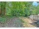 Backyard featuring wooded space with steps leading to upper deck area at 3158 Crestmont Nw Way, Kennesaw, GA 30152