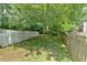 Picture of backyard showcasing a well-kept lawn, bordered by a charming white picket fence at 3158 Crestmont Nw Way, Kennesaw, GA 30152