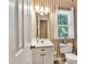 Small bathroom with striped wallpaper, and vanity with a sink and storage space at 3158 Crestmont Nw Way, Kennesaw, GA 30152