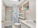 Cozy full bathroom with shower-tub combo, white vanity, and charming wallpaper at 3158 Crestmont Nw Way, Kennesaw, GA 30152