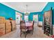 The dining room with blue walls is staged with a table, chandelier, and moving boxes at 3158 Crestmont Nw Way, Kennesaw, GA 30152