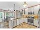 Well-lit kitchen features stainless steel appliances, granite counters, island, and eat-in breakfast nook at 3158 Crestmont Nw Way, Kennesaw, GA 30152