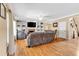 An open concept living room includes a brick fireplace, mounted TV and built-in shelving around the room at 3158 Crestmont Nw Way, Kennesaw, GA 30152