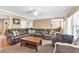 Spacious living room with a large sectional sofa, a coffee table, and large windows offering natural light at 3158 Crestmont Nw Way, Kennesaw, GA 30152