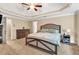 This primary bedroom is complete with a tray ceiling, fan and neutral colored carpet and paint at 3158 Crestmont Nw Way, Kennesaw, GA 30152
