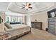 Large bedroom featuring an attractive tray ceiling, ceiling fan, sitting area and lots of storage at 3158 Crestmont Nw Way, Kennesaw, GA 30152