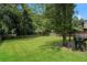 A verdant, well-kept lawn is bordered by a sturdy wooden fence with mature trees in the background at 5107 Rails Way, Norcross, GA 30071