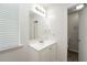 A bathroom features a vanity, framed mirror, overhead lighting and a window with white blinds at 5107 Rails Way, Norcross, GA 30071