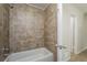This bathroom has a shower and tub with beige tile surround, white trim and neutral paint at 5107 Rails Way, Norcross, GA 30071