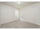 A bedroom with neutral walls and plush carpet features a window with white blinds at 5107 Rails Way, Norcross, GA 30071