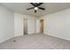 A spacious bedroom has neutral walls, plush gray carpet, and is adjacent to a bathroom and closet at 5107 Rails Way, Norcross, GA 30071