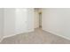 A carpeted bedroom has a closet and an open doorway into another room at 5107 Rails Way, Norcross, GA 30071