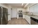 Kitchen with stainless steel appliances, granite counters, and white cabinets at 5107 Rails Way, Norcross, GA 30071