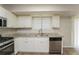 Kitchen featuring granite countertops, stainless steel appliances, and white cabinets at 5107 Rails Way, Norcross, GA 30071