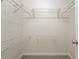 A walk-in closet is equipped with metal shelving units for clothing storage and organization at 5107 Rails Way, Norcross, GA 30071