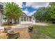 Inviting backyard oasis with a well-maintained lawn, outdoor seating area, and inviting pool with attached hot tub at 6394 Wood Valley Rd, Douglasville, GA 30134