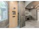 Modern bathroom featuring a spa-like shower, sleek gray tiling, and double sink vanity with illuminated mirror at 6394 Wood Valley Rd, Douglasville, GA 30134