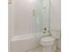 Bathroom showcasing a tub-shower combo with patterned tile walls, a glass door, and gold fixtures at 6394 Wood Valley Rd, Douglasville, GA 30134