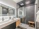 Modern bathroom featuring a dual vanity, stone-tiled shower, and recessed lighting at 6394 Wood Valley Rd, Douglasville, GA 30134
