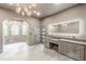 Elegant bathroom featuring modern lighting, vanity with dual sinks, and glass enclosed shower at 6394 Wood Valley Rd, Douglasville, GA 30134
