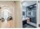 Hallway view showcasing the modern bathroom with dual vanity and glass shower at 6394 Wood Valley Rd, Douglasville, GA 30134