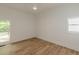 Bright bedroom with a ceiling fan, wood-look floors, and a window with outside view at 6394 Wood Valley Rd, Douglasville, GA 30134