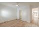 Bright bedroom with wood-look floors, ceiling fan, and access to an ensuite bathroom and closet at 6394 Wood Valley Rd, Douglasville, GA 30134