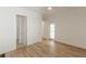 Bedroom featuring wood-look floors, white walls, trim, and doors, creating a bright interior at 6394 Wood Valley Rd, Douglasville, GA 30134