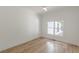 Bright bedroom featuring wood-look floors, modern trim, and a window offering natural light at 6394 Wood Valley Rd, Douglasville, GA 30134
