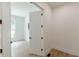 Hallway view to a bright room with light wood-look floors and a large window providing natural light at 6394 Wood Valley Rd, Douglasville, GA 30134