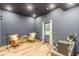 Bright bonus room with wood floors, recessed lighting, and comfortable seating at 6394 Wood Valley Rd, Douglasville, GA 30134