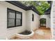 Charming courtyard with brick pathway, brick half-wall, and an arched gate, offering a private outdoor space at 6394 Wood Valley Rd, Douglasville, GA 30134