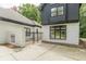 Rear of the home showcases a quaint courtyard area enclosed by white brick walls, perfect for outdoor enjoyment at 6394 Wood Valley Rd, Douglasville, GA 30134