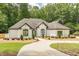 Charming single story home with fresh landscaping, white brick, and dark trim at 6394 Wood Valley Rd, Douglasville, GA 30134