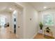 Bright hallway featuring hardwood floors and natural light from a window at 6394 Wood Valley Rd, Douglasville, GA 30134