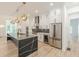 Modern kitchen with a large island, stainless steel appliances and stylish pendant lighting at 6394 Wood Valley Rd, Douglasville, GA 30134