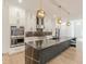 Elegant kitchen featuring white cabinets, stainless steel appliances, and a spacious island with a black countertop at 6394 Wood Valley Rd, Douglasville, GA 30134