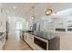 Bright, modern kitchen with a large island, stainless steel appliances, and an open layout to the living area at 6394 Wood Valley Rd, Douglasville, GA 30134