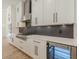 Contemporary kitchen with stainless steel appliances, white cabinets, and a built-in wine fridge at 6394 Wood Valley Rd, Douglasville, GA 30134