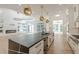 Spacious kitchen open to living areas, featuring stainless appliances, modern lighting, and large island at 6394 Wood Valley Rd, Douglasville, GA 30134