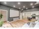 Bright, open living area with projector screen, modern finishes, and adjacent kitchen at 6394 Wood Valley Rd, Douglasville, GA 30134