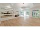 Bright living room with wood floors, fireplace, and view of the modern kitchen at 6394 Wood Valley Rd, Douglasville, GA 30134