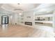 Spacious living area with built-in shelving, modern fireplace, and a view to the kitchen at 6394 Wood Valley Rd, Douglasville, GA 30134
