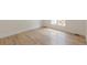 Light hardwood flooring in a bright, modern living room space with a window at 6394 Wood Valley Rd, Douglasville, GA 30134