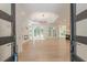 Open-concept living room with a fireplace, modern light fixture, and beautiful wood floors at 6394 Wood Valley Rd, Douglasville, GA 30134