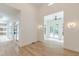 Spacious living room with high ceilings, large windows, and modern lighting fixtures at 6394 Wood Valley Rd, Douglasville, GA 30134